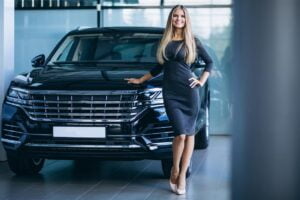 young-woman-choosing-car-car-showroom